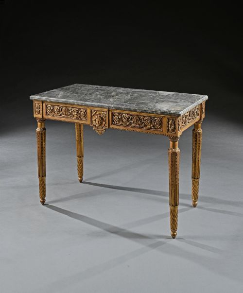 fig 2. An 18th-century Italian Neoclassical console table featuring a grey veined marble top, an intricate giltwood frieze with a central carved mask, and fluted legs.
