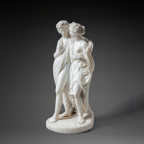 fig 1. A hand-carved white marble Neoclassical sculpture depicting the classical mythological figures of Bacchus and Ariadne standing together on a circular integral base.