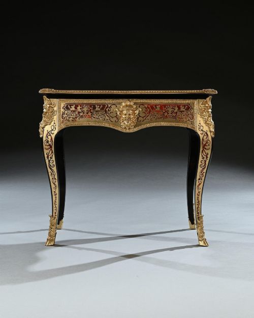 fig 2. A George IV period Boulle marquetry games table featuring brass and tortoiseshell inlay, gilt-bronze mounts, cabriole legs, and an inlaid chessboard top.