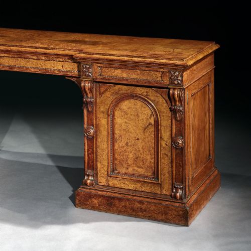 fig 1. A mid-19th century Victorian pollard oak pedestal sideboard featuring arched panelled doors, carved corbels, and figured wood grain.