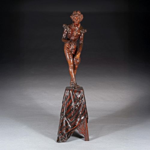 fig 4. A pair of carved brown wood figures depicting Renaissance figures atop detailed wooden bases.