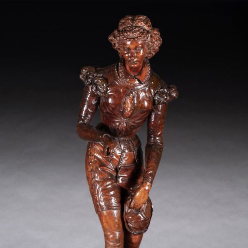 fig 5. A pair of carved brown wood figures depicting Renaissance figures atop detailed wooden bases.