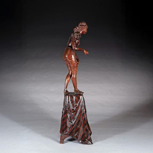fig 7. A pair of carved brown wood figures depicting Renaissance figures atop detailed wooden bases.