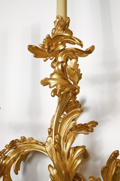 fig 2. A pair of 19th-century French Rococo three-branch wall lights crafted from gilded bronze with asymmetrical acanthus leaf scrollwork.