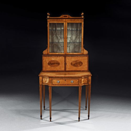 fig 2. An 18th-century George III satinwood writing cabinet featuring an astragal-glazed upper section, oval marquetry inlays, and square tapered legs.