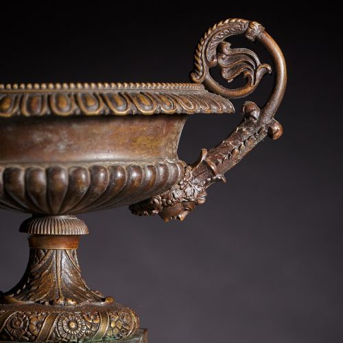 fig 4. A pair of early nineteenth-century French bronze tazzas with scrolled handles resting on square yellow veined marble pedestal bases.