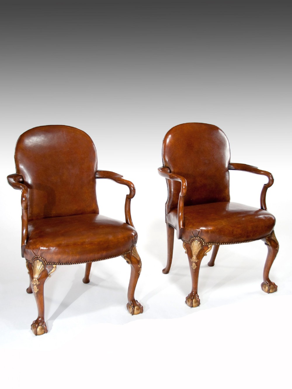 A Superb Pair of Walnut Parcel Gilt Leather Desk Chairs