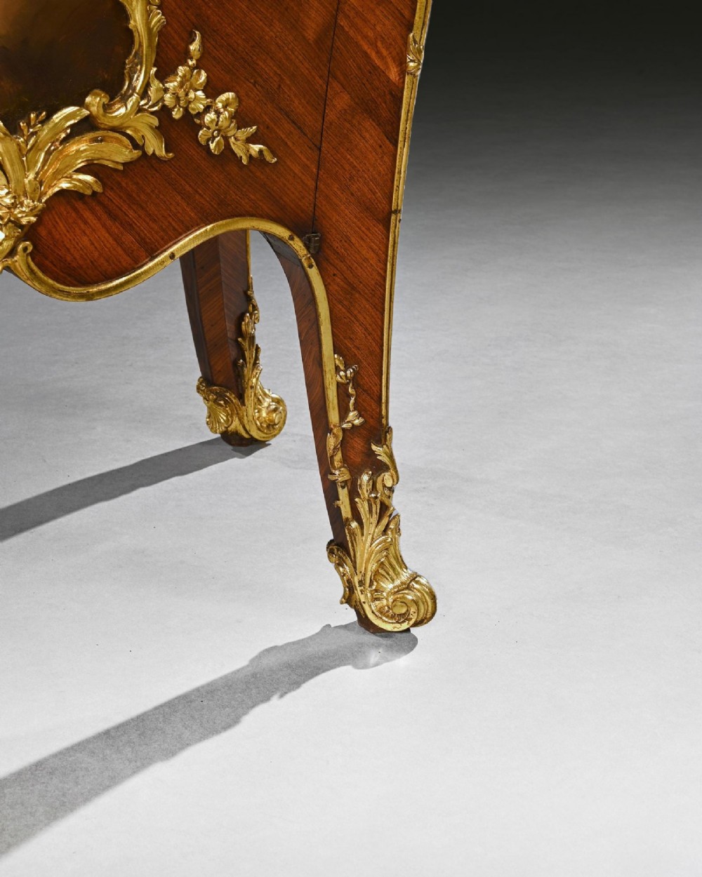 A pair of 19th-century French kingwood petit commodes featuring shaped marble tops, gilt-bronze mounts, cabriole legs, and Vernis Martin hand-painted panels depicting classical figures. View V