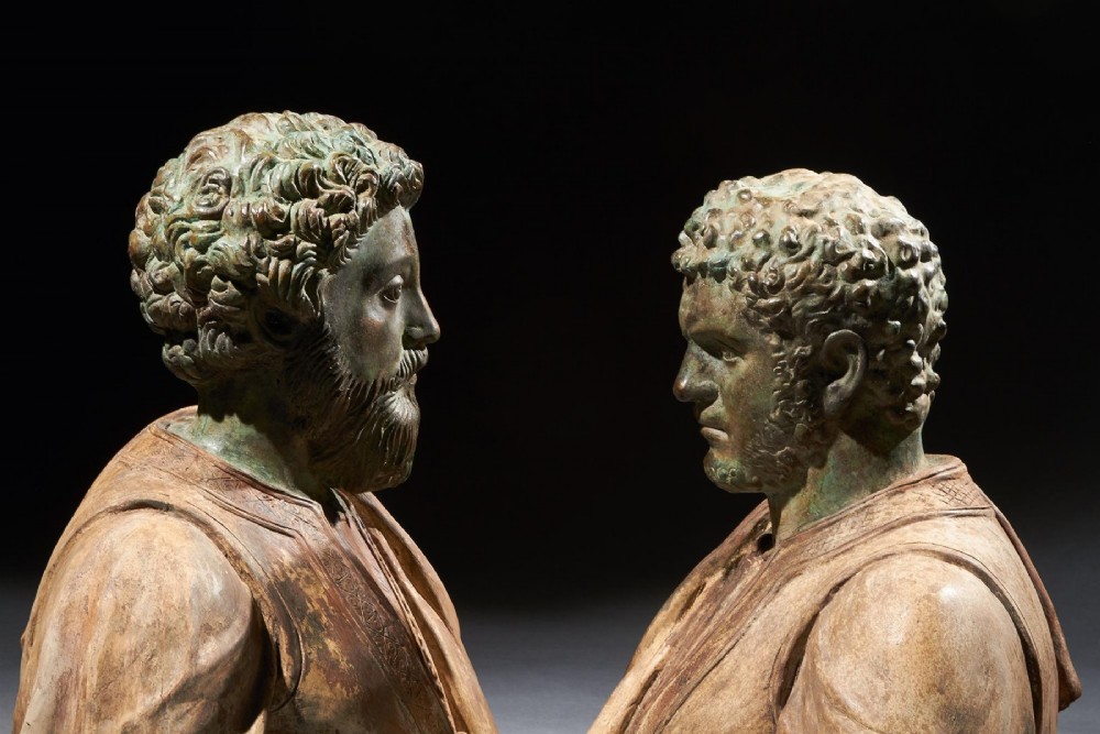 A pair of late nineteenth-century terracotta portrait busts depicting Roman Emperors Marcus Aurelius and Caracalla with verdigris-tinted heads and draped garments. View VIII