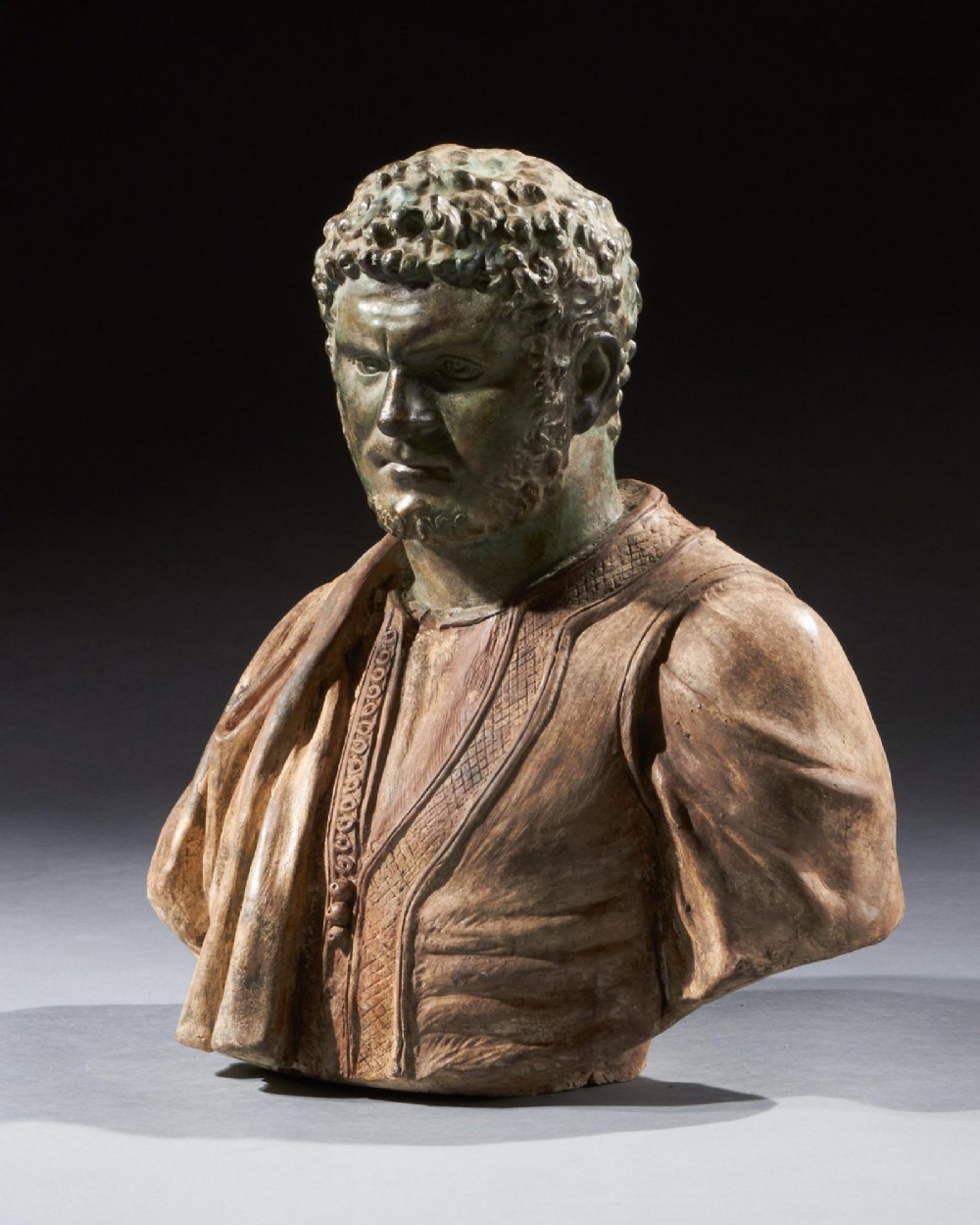 A pair of late nineteenth-century terracotta portrait busts depicting Roman Emperors Marcus Aurelius and Caracalla with verdigris-tinted heads and draped garments. View X