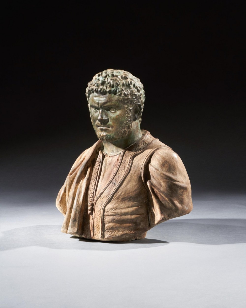 A pair of late nineteenth-century terracotta portrait busts depicting Roman Emperors Marcus Aurelius and Caracalla with verdigris-tinted heads and draped garments. View XI