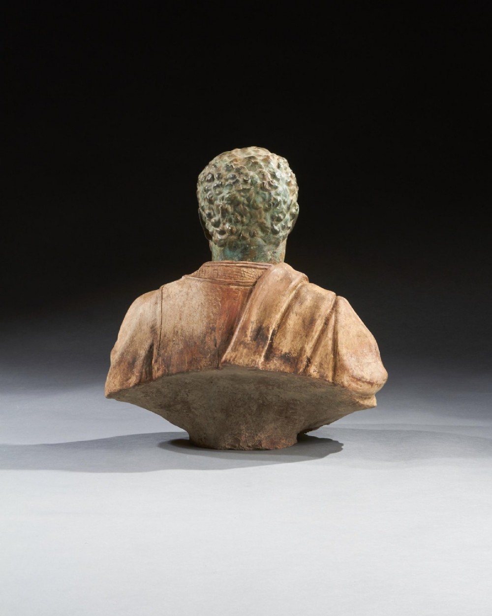 A pair of late nineteenth-century terracotta portrait busts depicting Roman Emperors Marcus Aurelius and Caracalla with verdigris-tinted heads and draped garments. View XIII