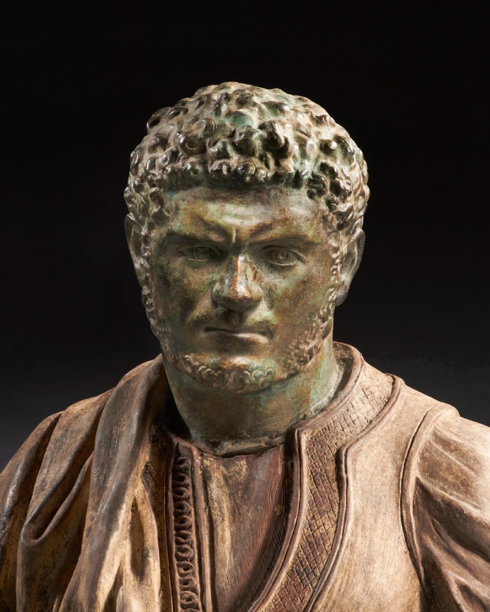 A pair of late nineteenth-century terracotta portrait busts depicting Roman Emperors Marcus Aurelius and Caracalla with verdigris-tinted heads and draped garments. View XIV