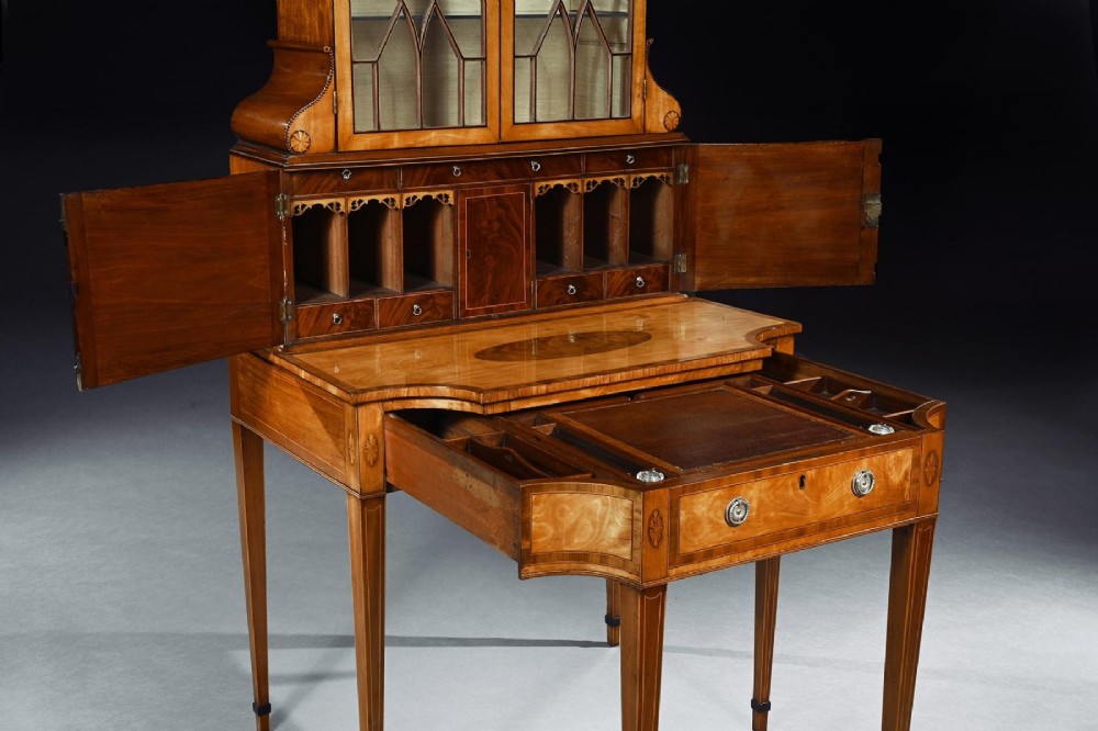 An 18th-century George III satinwood writing cabinet with a glazed upper bookcase, oval inlaid cupboard doors, and slender tapered legs. View VII
