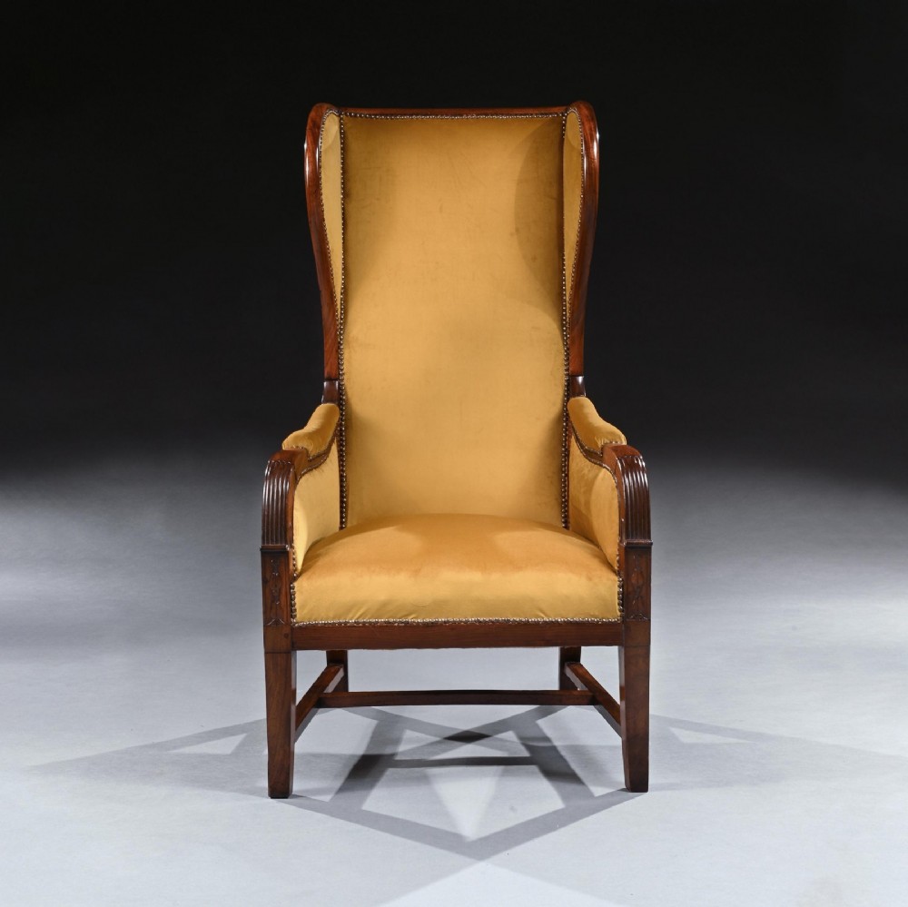 A French Empire style reclining wing back armchair with dark mahogany framing, brass stud detailing, and yellow velvet upholstery. View II