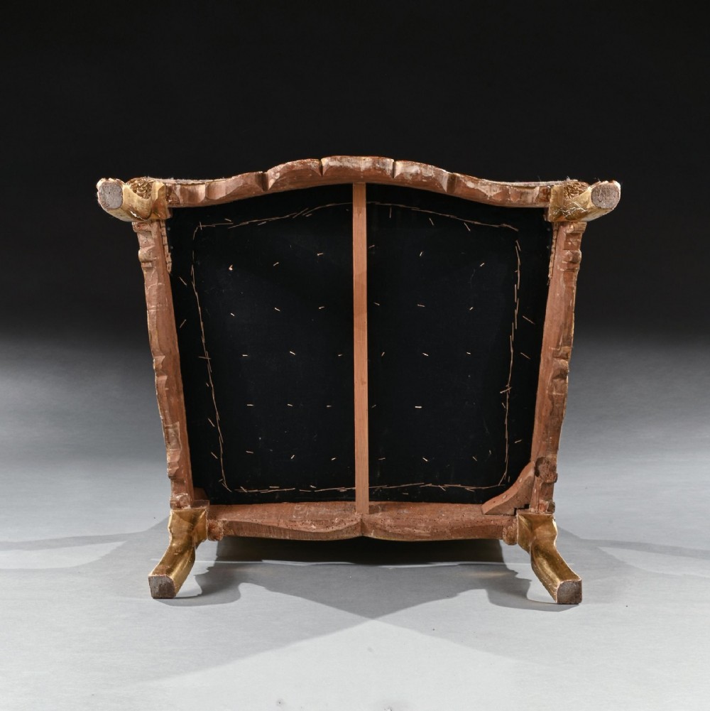 An 18th-century French Regence giltwood armchair featuring ornate shell carving, cabriole legs, and tapestry upholstery depicting figures and floral motifs. View VIII