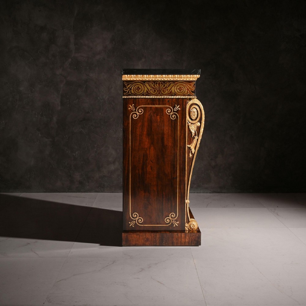 A pair of dark wood Regency side cabinets featuring intricate brass inlaid foliage, gilt corner mounts, brass wire mesh doors, and dark marble tops. View VI