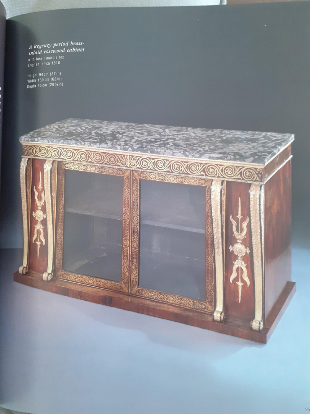 A pair of dark wood Regency side cabinets featuring intricate brass inlaid foliage, gilt corner mounts, brass wire mesh doors, and dark marble tops. View VIII