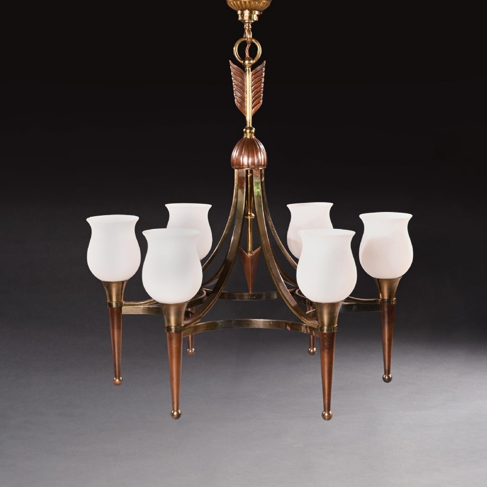 A mid-century brass and copper six-arm chandelier featuring a central arrow motif and frosted tulip glass shades.
