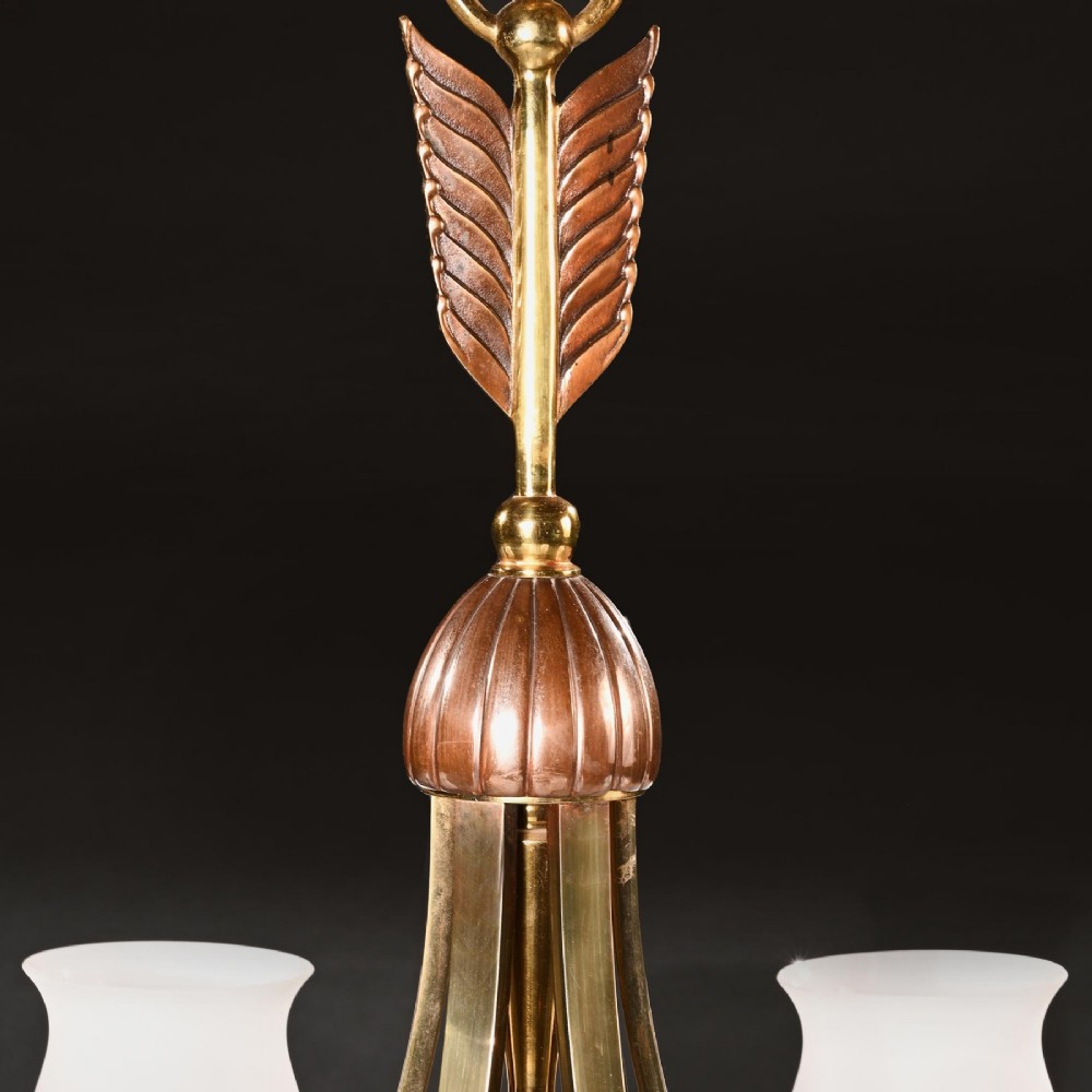 A mid-century brass and copper six-arm chandelier featuring a central arrow motif and frosted tulip glass shades. View V