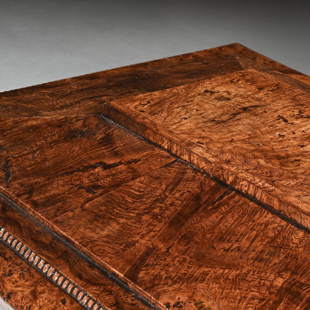 A George IV sarcophagus-shaped cellarette crafted from figured pollard oak with a stepped lid and beaded moulding on a plinth base. View VII