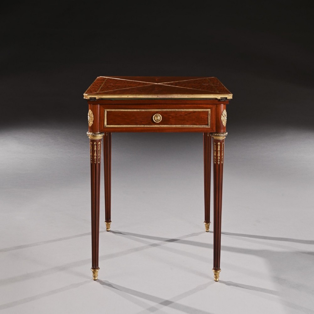 A square mahogany envelope card table with gilt bronze mounts, fluted tapered legs, and four triangular folding top flaps. View II
