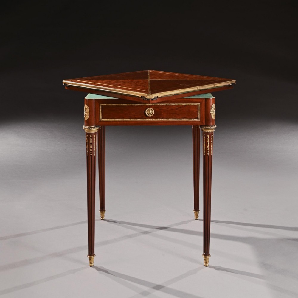 A square mahogany envelope card table with gilt bronze mounts, fluted tapered legs, and four triangular folding top flaps. View IV