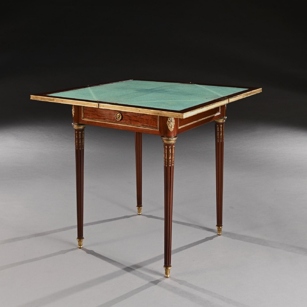 A square mahogany envelope card table with gilt bronze mounts, fluted tapered legs, and four triangular folding top flaps. View VI