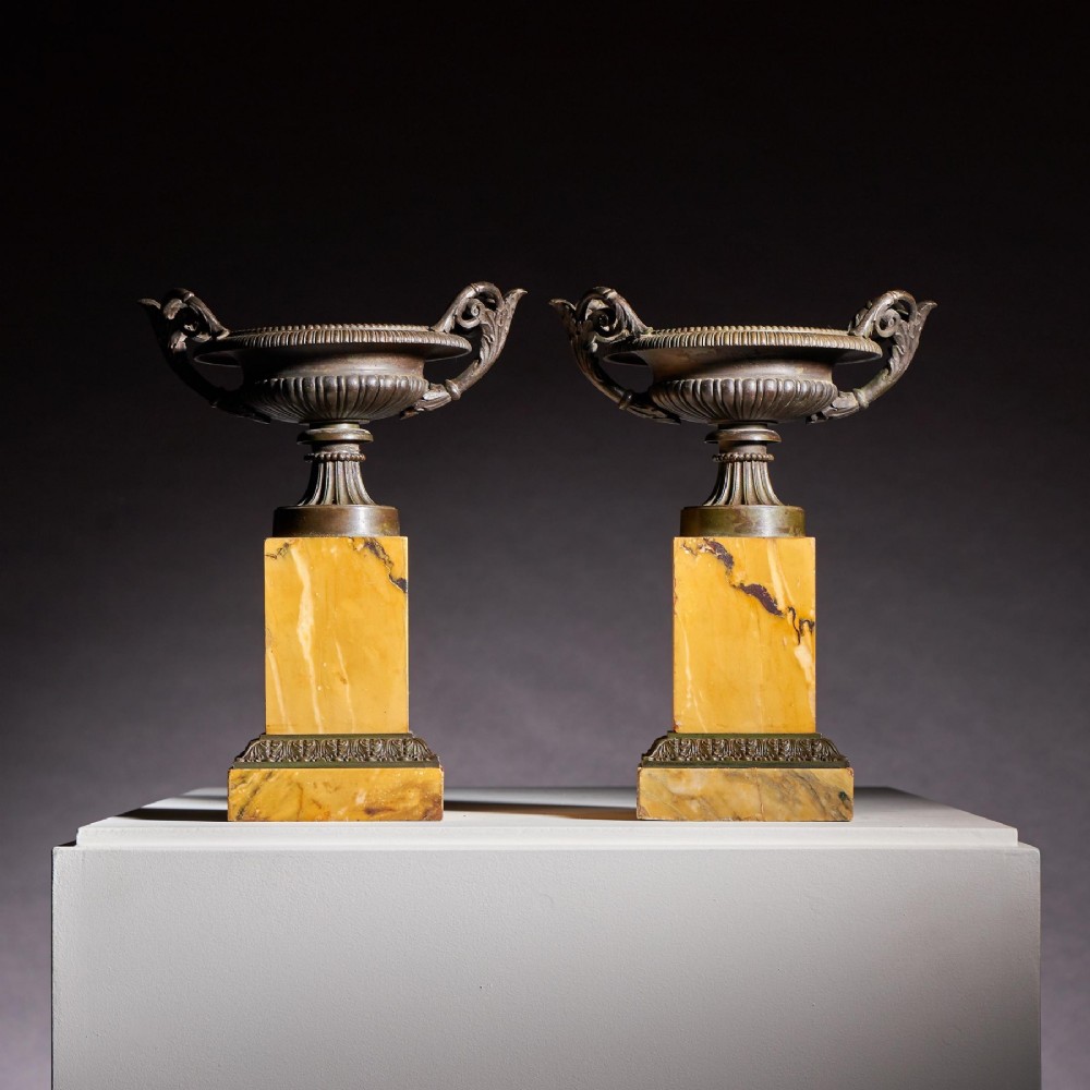 A pair of early 19th-century French Grand Tour bronze tazzas featuring fluted rims and scrolled handles set upon tall yellow Siena marble pedestal bases. View II