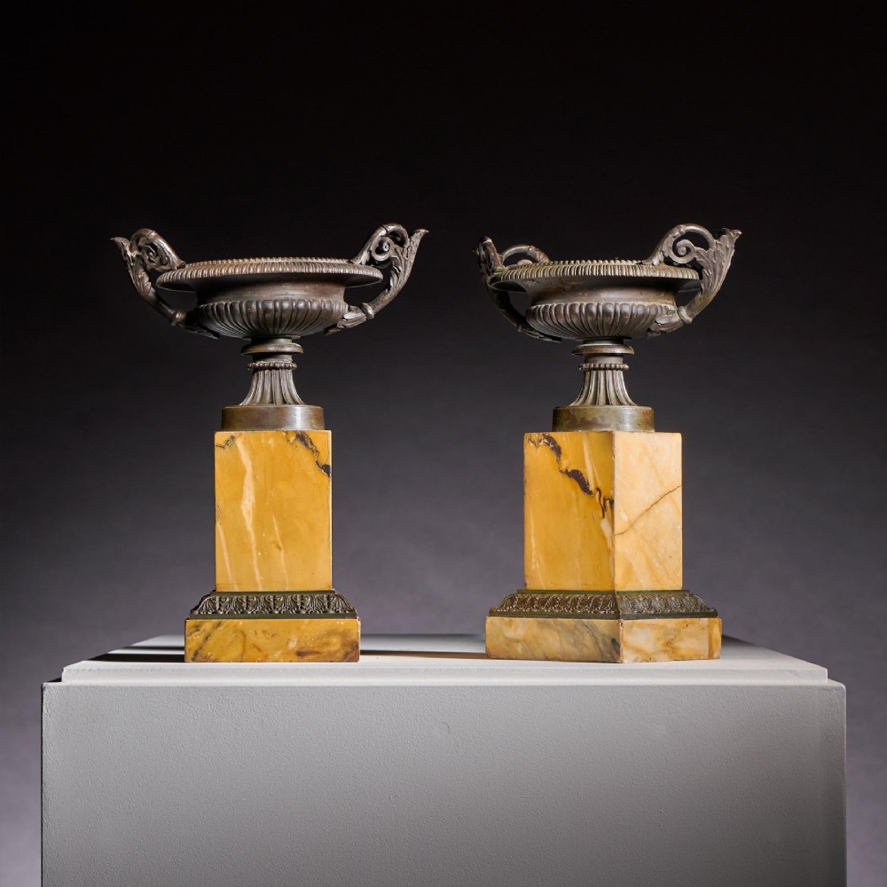 A pair of early 19th-century French Grand Tour bronze tazzas featuring fluted rims and scrolled handles set upon tall yellow Siena marble pedestal bases. View III