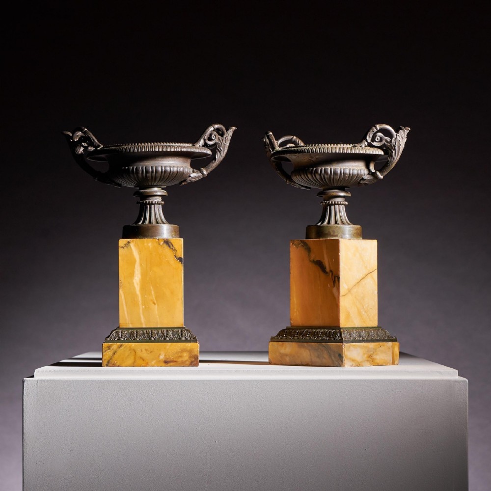 A pair of early 19th-century French Grand Tour bronze tazzas featuring fluted rims and scrolled handles set upon tall yellow Siena marble pedestal bases. View IV