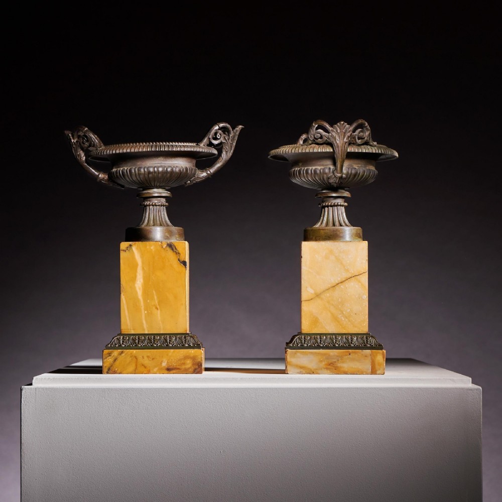 A pair of early 19th-century French Grand Tour bronze tazzas featuring fluted rims and scrolled handles set upon tall yellow Siena marble pedestal bases. View V