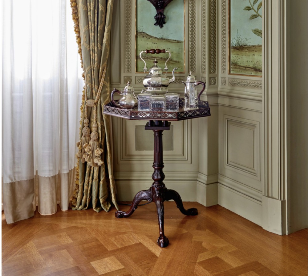 A George III dark mahogany octagonal tripod table featuring a pierced fretwork gallery top, fluted column, and carved legs with claw-and-ball feet. View VI