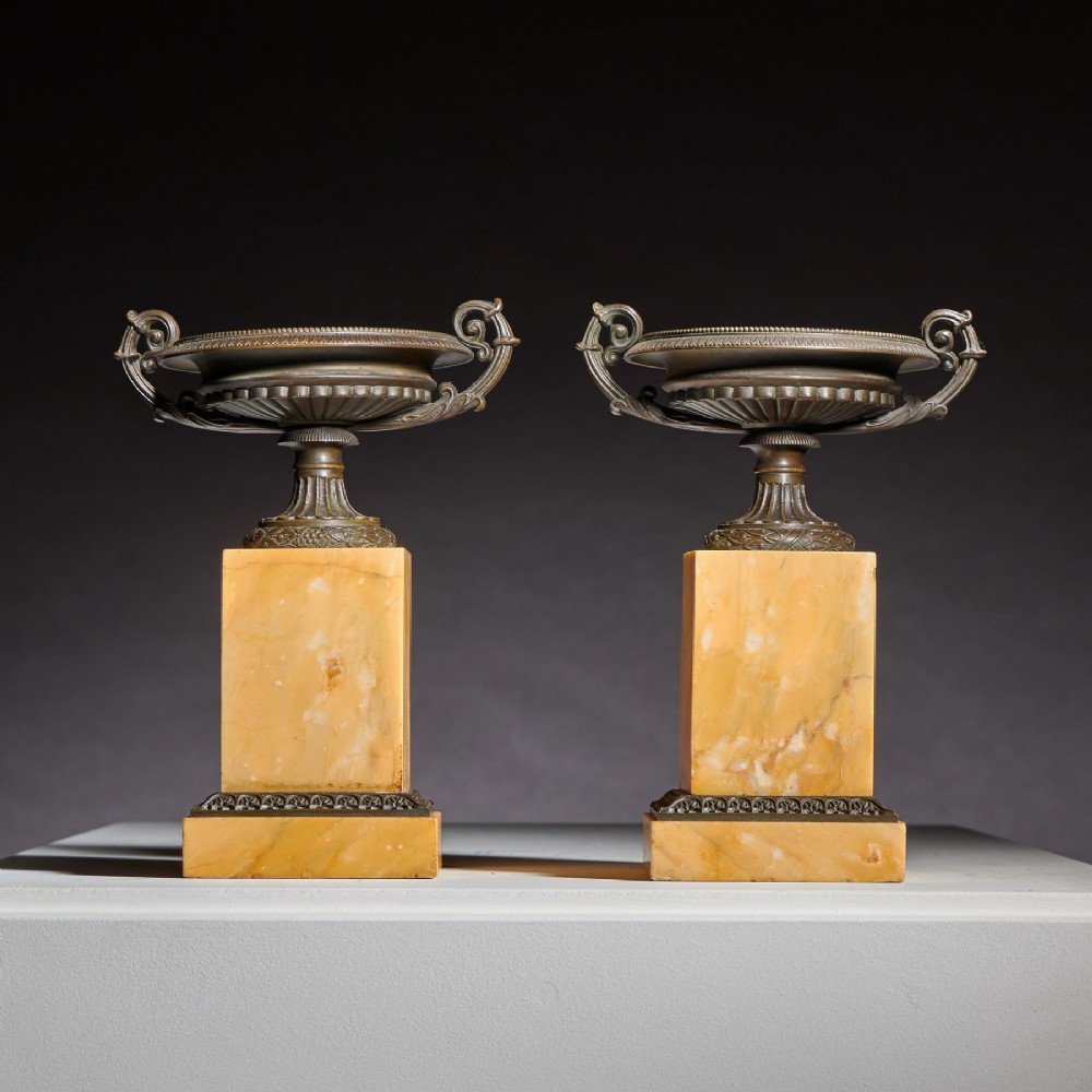 A pair of early 19th-century bronze tazzas with scroll handles mounted upon tall rectangular yellow Siena marble plinths. View III
