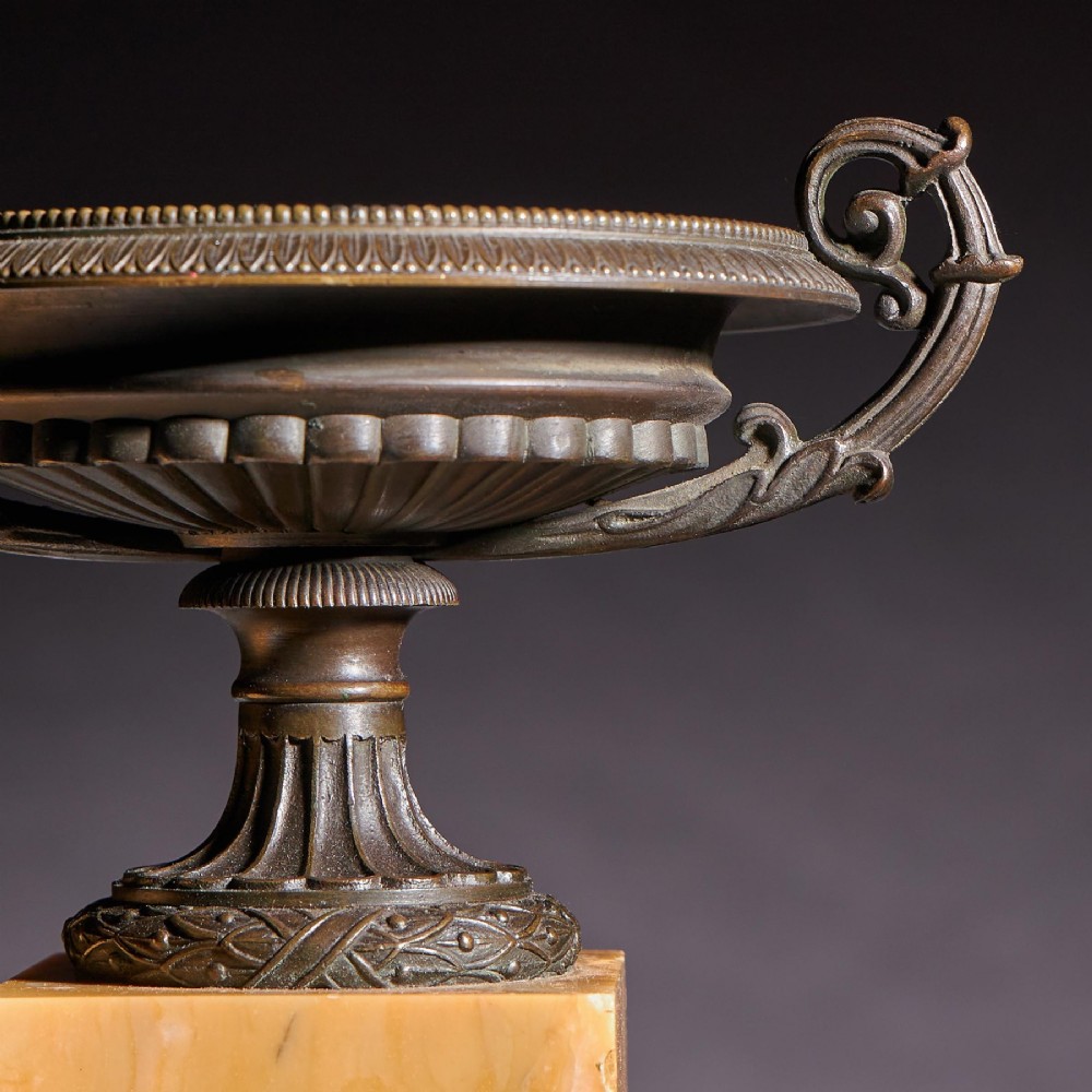 A pair of early 19th-century bronze tazzas with scroll handles mounted upon tall rectangular yellow Siena marble plinths. View IV