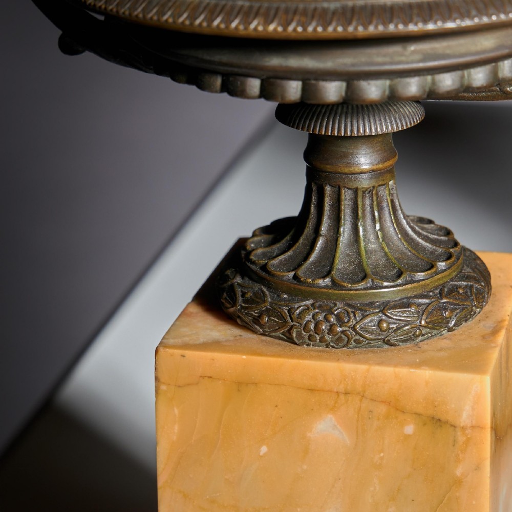 A pair of early 19th-century bronze tazzas with scroll handles mounted upon tall rectangular yellow Siena marble plinths. View VII