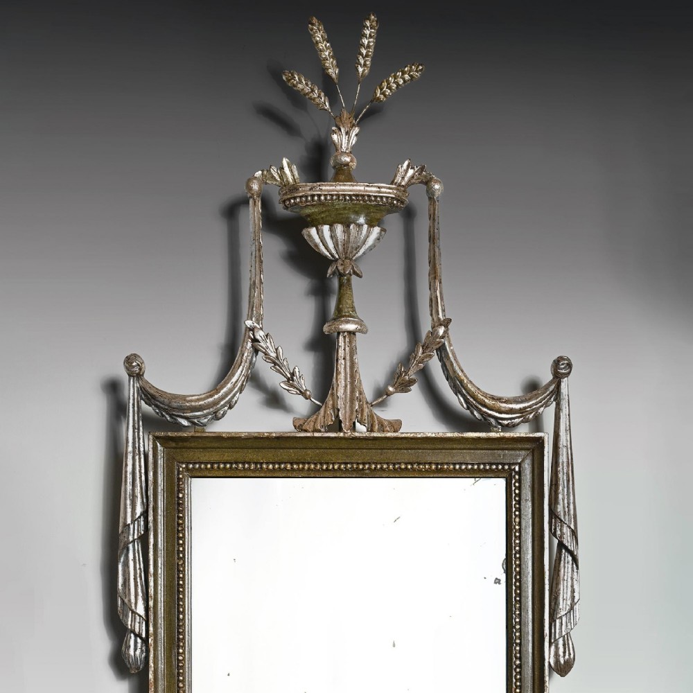 A set of three 19th-century Neoclassical wall mirrors featuring green painted and silvered frames topped with carved urn finials and drapery swags. View II