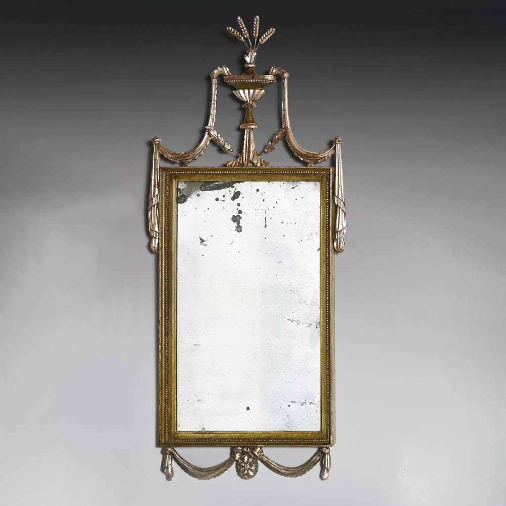 A set of three 19th-century Neoclassical wall mirrors featuring green painted and silvered frames topped with carved urn finials and drapery swags. View V