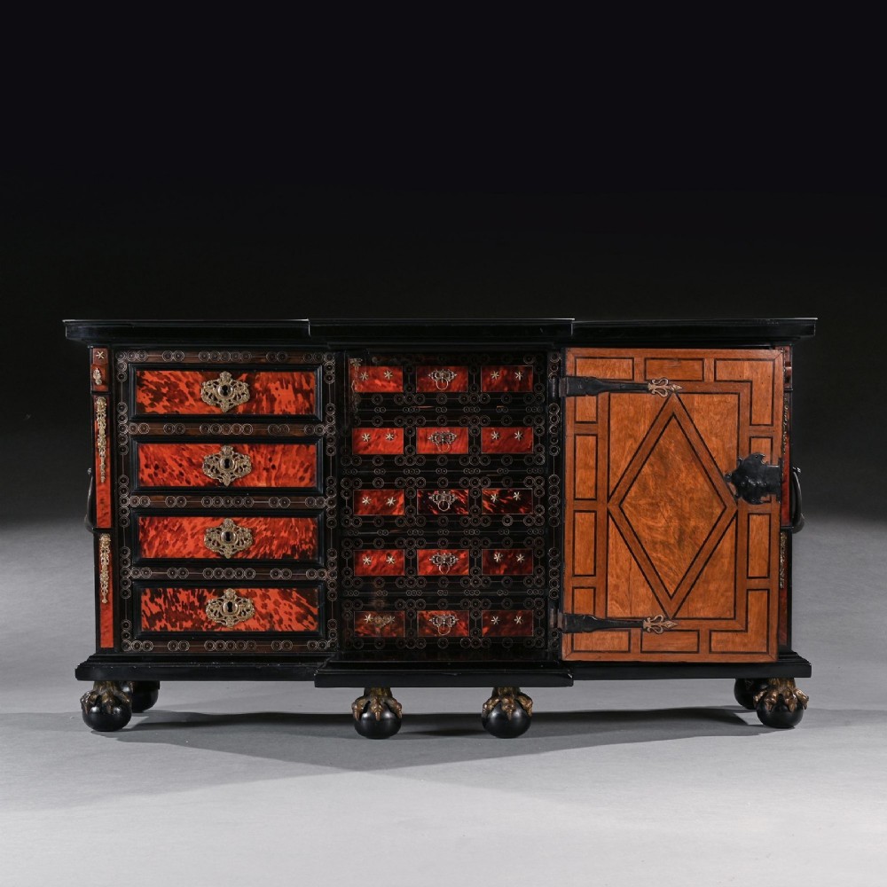 A pair of seventeenth-century Spanish Baroque ebonised and tortoiseshell cabinets featuring architectural central doors and gilt bronze mounts, elevated on tall metal stands. View VII