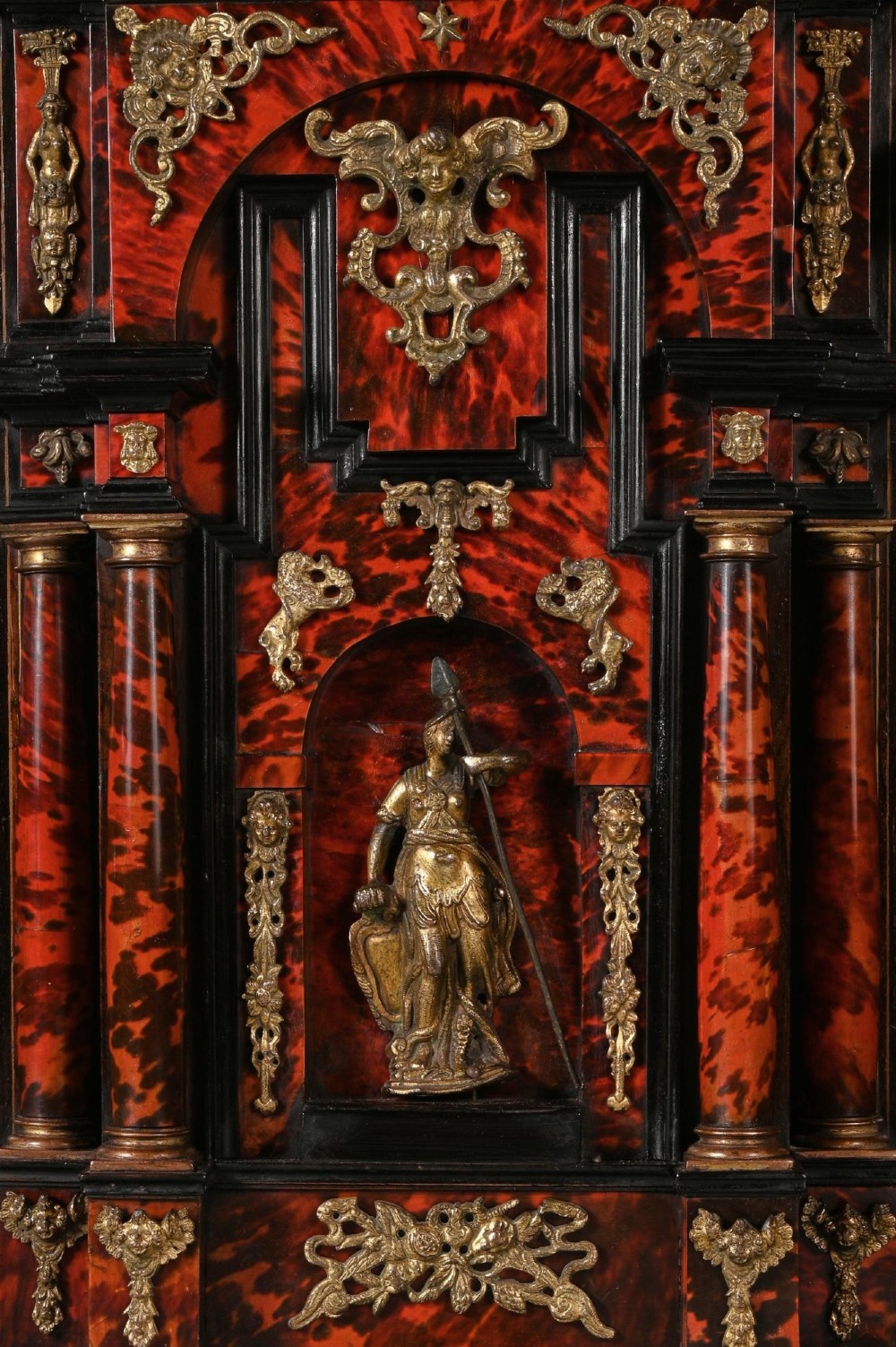 A pair of seventeenth-century Spanish Baroque ebonised and tortoiseshell cabinets featuring architectural central doors and gilt bronze mounts, elevated on tall metal stands. View IX
