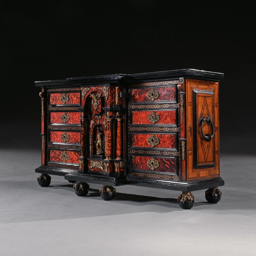 A pair of seventeenth-century Spanish Baroque ebonised and tortoiseshell cabinets featuring architectural central doors and gilt bronze mounts, elevated on tall metal stands. View XII
