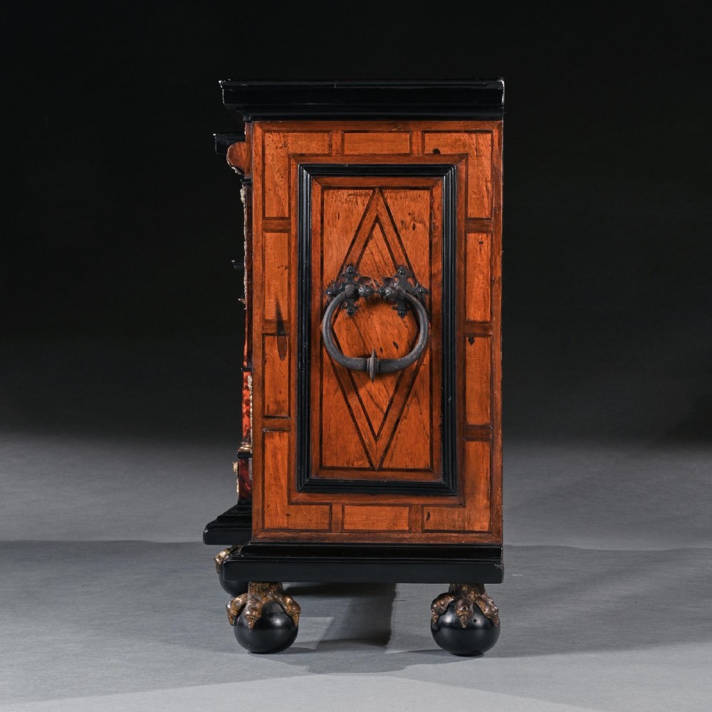 A pair of seventeenth-century Spanish Baroque ebonised and tortoiseshell cabinets featuring architectural central doors and gilt bronze mounts, elevated on tall metal stands. View XIII