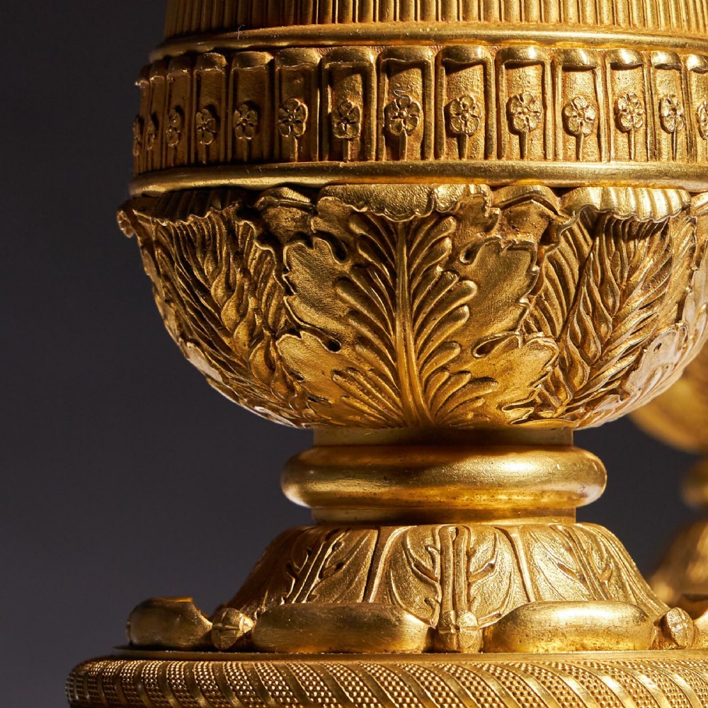 A pair of French Empire gilt bronze candelabra featuring winged Victory figures supporting multi-arm candle holders on pedestals. View VIII