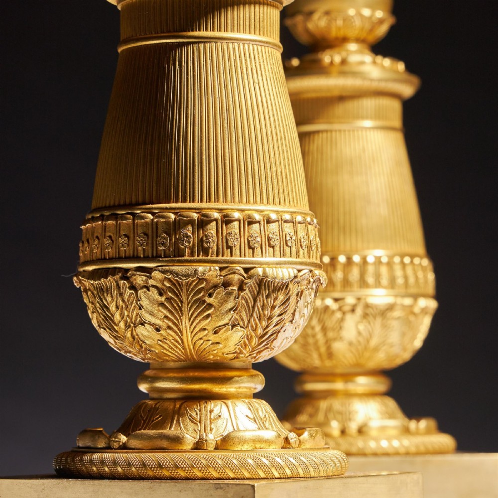 A pair of French Empire gilt bronze candelabra featuring winged Victory figures supporting multi-arm candle holders on pedestals. View X