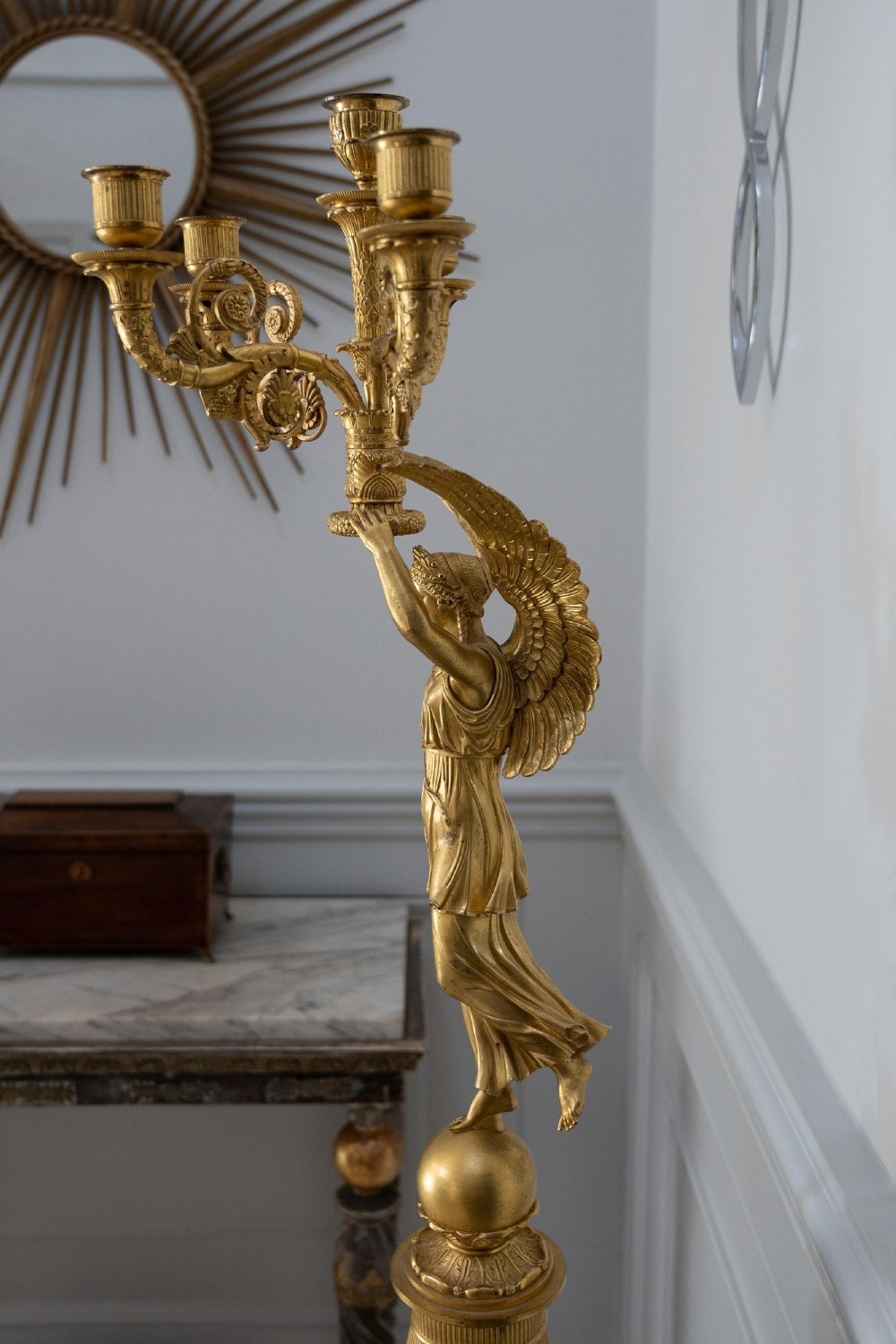 A pair of French Empire gilt bronze candelabra featuring winged Victory figures supporting multi-arm candle holders on pedestals. View XIII