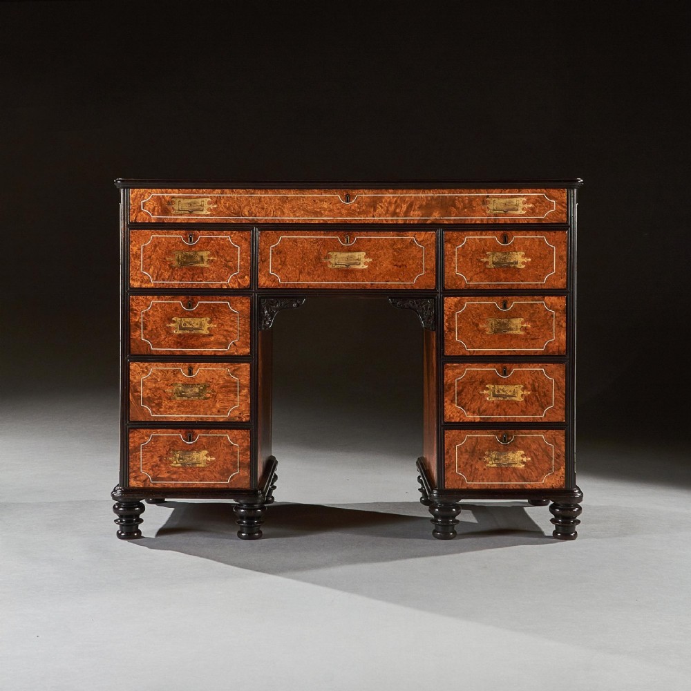 A 19th-century Chinese export kneehole campaign desk crafted from figured amboyna wood with ebony borders and brass carrying handles. View III