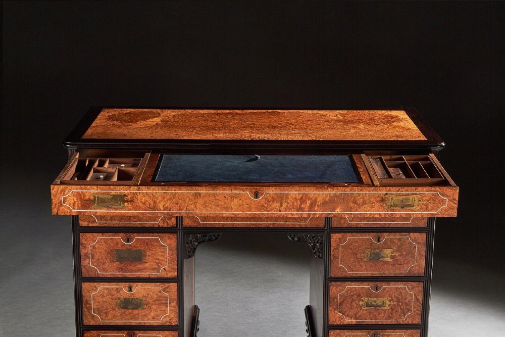 A 19th-century Chinese export kneehole campaign desk crafted from figured amboyna wood with ebony borders and brass carrying handles. View VII