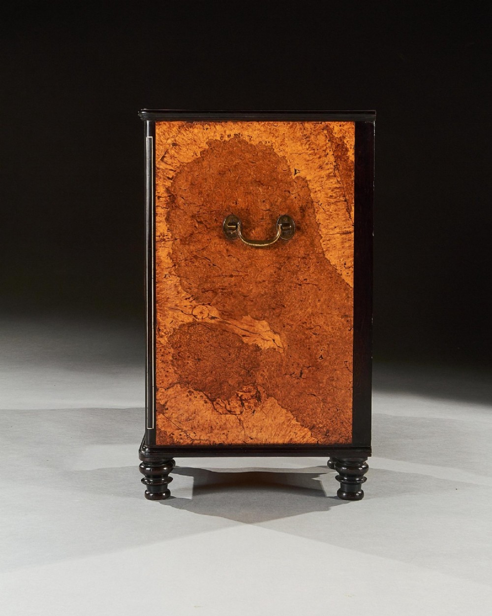 A 19th-century Chinese export kneehole campaign desk crafted from figured amboyna wood with ebony borders and brass carrying handles. View IX