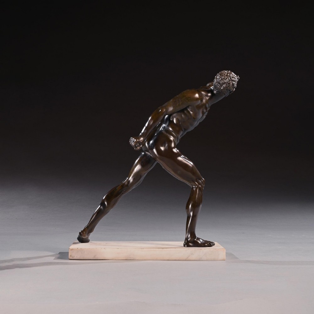 A 19th-century patinated bronze sculpture depicting the Borghese Gladiator in a dynamic lunging pose, mounted on a light-coloured marble base. View V