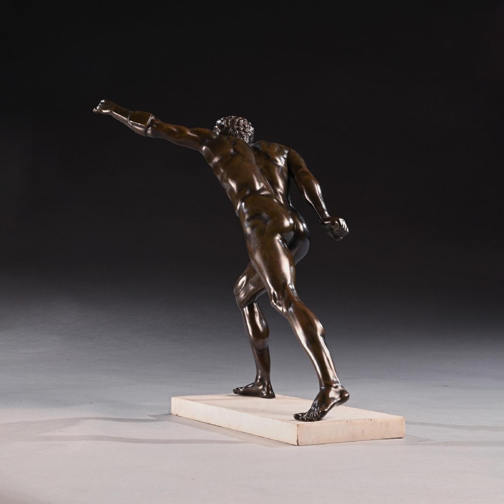 A 19th-century patinated bronze sculpture depicting the Borghese Gladiator in a dynamic lunging pose, mounted on a light-coloured marble base. View VI